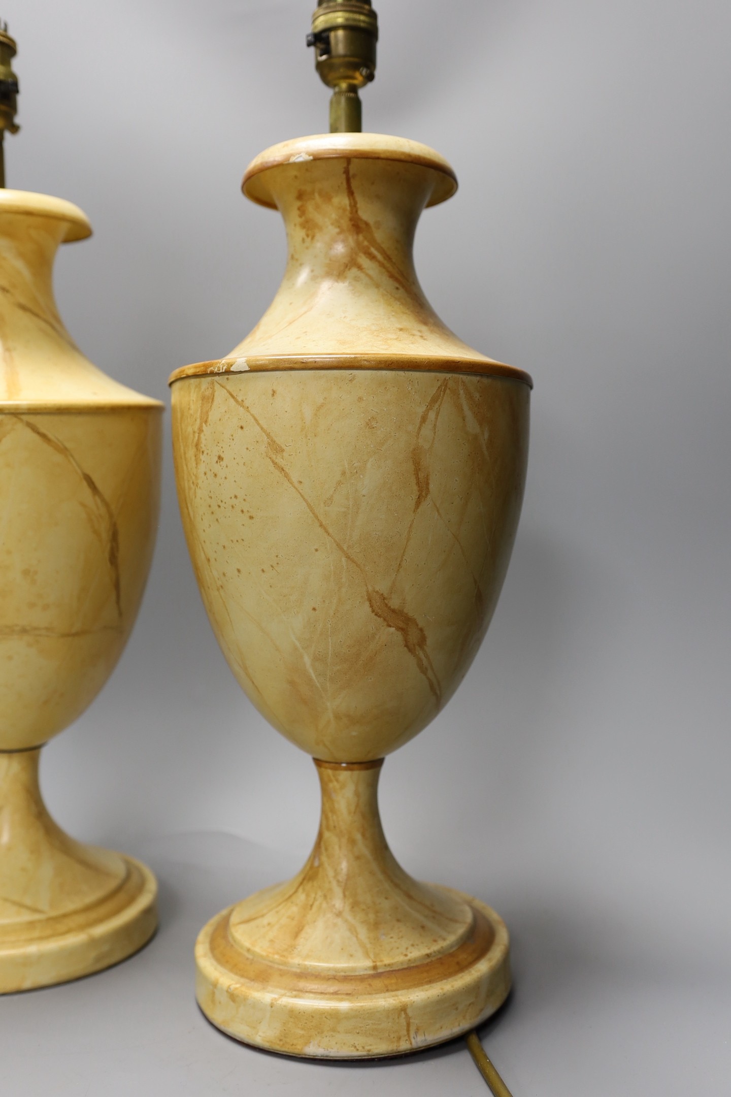 A pair of faux marble toleware style lamps, 41 cms high not including fittings